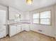 This kitchen offers ample cabinet space and a view to the outside at 405 Harlan St, Indianapolis, IN 46201