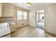 This kitchen offers ample cabinet space and a view to another room at 405 Harlan St, Indianapolis, IN 46201