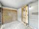 Enclosed porch features lattice paneling, screen door, and concrete flooring at 405 Harlan St, Indianapolis, IN 46201