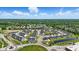Community aerial view showcasing a neighborhood with lush greenery and a pond, near shopping areas at 4182 Hume Ave, Plainfield, IN 46168