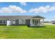 Expansive backyard with covered patio, white chairs, and manicured lawn at 4182 Hume Ave, Plainfield, IN 46168