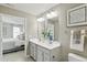 Bright bathroom with double vanity, large mirrors, and en suite bedroom access at 4182 Hume Ave, Plainfield, IN 46168