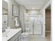 Clean bathroom with bright white vanity, large mirrors, and glass-enclosed shower at 4182 Hume Ave, Plainfield, IN 46168