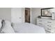 Bright bedroom featuring a large dresser, stylish mirror, and comfortable, striped bedding at 4182 Hume Ave, Plainfield, IN 46168