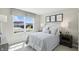 Bright bedroom with a large window offering community views, and rustic nightstands at 4182 Hume Ave, Plainfield, IN 46168