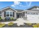 Charming home featuring a stone facade, attached two-car garage and beautiful landscaping at 4182 Hume Ave, Plainfield, IN 46168