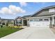 Charming one-story home showcasing stone accents, gray siding, a well-manicured lawn, and a two-car garage at 4182 Hume Ave, Plainfield, IN 46168