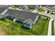 An exterior view showing the backyard with covered patio and seating, set on a lush green lawn at 4182 Hume Ave, Plainfield, IN 46168