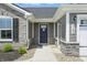 Welcoming front entrance showcasing a stylish gray door, stone accents, and modern exterior lighting at 4182 Hume Ave, Plainfield, IN 46168