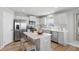 Bright kitchen features stainless steel appliances, white cabinets, and a central island with bar seating at 4182 Hume Ave, Plainfield, IN 46168