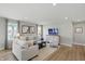 Inviting living room with hardwood floors, neutral decor, and large windows for plenty of natural light at 4182 Hume Ave, Plainfield, IN 46168