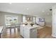 Open-concept living and dining area with hardwood floors, large windows, and access to the kitchen at 4182 Hume Ave, Plainfield, IN 46168