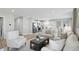 Bright and open living room with hardwood floors, neutral decor, and an adjoining kitchen at 4182 Hume Ave, Plainfield, IN 46168