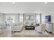 Bright living room featuring neutral decor, hardwood floors, and ample natural light from large windows at 4182 Hume Ave, Plainfield, IN 46168