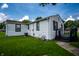View of the yard with vinyl siding, black deck and an air conditioning condenser outside at 4639 Terrace Ave, Indianapolis, IN 46203