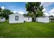 Image showing a well-maintained vinyl sided house, garage and a large tree in the backyard at 4639 Terrace Ave, Indianapolis, IN 46203