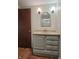 Bathroom boasts modern vanity with sink, stylish lighting, and mirror at 5052 Helmsburg School Rd, Morgantown, IN 46160