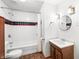 Bathroom with white tiled walls, shower, vanity, and dark finished floors at 5052 Helmsburg School Rd, Morgantown, IN 46160