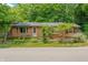 Charming exterior view of a cozy home with a quaint fence and lush greenery at 5052 Helmsburg School Rd, Morgantown, IN 46160