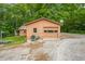 Charming single-car garage with shed and quaint yard décor provides storage and complements the surrounding greenery at 5052 Helmsburg School Rd, Morgantown, IN 46160