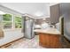 A well-lit kitchen is equipped with stainless steel appliances and laminate countertop at 5052 Helmsburg School Rd, Morgantown, IN 46160