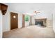This living room features a stone fireplace and neutral-toned carpet at 5052 Helmsburg School Rd, Morgantown, IN 46160