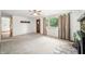 Large living room with stone fireplace, large window, carpet and access to other rooms at 5052 Helmsburg School Rd, Morgantown, IN 46160