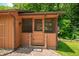 A screened-in porch features wood trim, American flag, and a brick walkway at 5052 Helmsburg School Rd, Morgantown, IN 46160