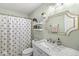 Bright bathroom features a granite countertop vanity, decorative mirror, and cute mushroom patterned shower curtain at 5299 Breakers Way, Carmel, IN 46033
