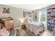 Cozy bedroom featuring neutral colors, a wood dresser, guitar, and bookshelf at 5299 Breakers Way, Carmel, IN 46033
