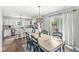 Dining area with backyard views, decorative lighting, and an adjacent kitchen with stainless appliances at 5299 Breakers Way, Carmel, IN 46033