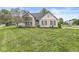 Well-maintained home featuring a lush green lawn and beautiful landscaping surrounding the property at 5299 Breakers Way, Carmel, IN 46033