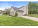 Well-maintained home with a two-car garage, manicured lawn, and lush landscaping at 5299 Breakers Way, Carmel, IN 46033