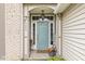 Charming front porch featuring a light blue door, brick accents, and decorative plants for a welcoming entry at 5299 Breakers Way, Carmel, IN 46033