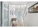 Bright foyer boasts tile flooring, staircase, and a stylish console table with a pale blue entry door at 5299 Breakers Way, Carmel, IN 46033