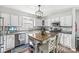 Bright kitchen features white cabinets, stainless steel appliances, granite countertops, and a butcher block island at 5299 Breakers Way, Carmel, IN 46033