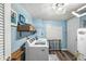 Functional laundry room with a washing machine, shelving, and ample space at 5299 Breakers Way, Carmel, IN 46033