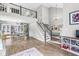 Open concept living room with a loft view, hardwood floors, and ample natural light at 5299 Breakers Way, Carmel, IN 46033