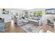 Bright living room with neutral tones, comfortable seating, and an open view to the dining area and backyard at 5299 Breakers Way, Carmel, IN 46033