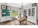 Bright and airy workspace with wooden table, large windows, and stylish storage, perfect for creativity at 5299 Breakers Way, Carmel, IN 46033