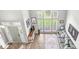 Bright living room showcasing a large window, hardwood floors, and neutral-toned sofa at 5299 Breakers Way, Carmel, IN 46033