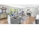 Cozy living room with hardwood floors, a fireplace, large windows, and comfortable seating at 5299 Breakers Way, Carmel, IN 46033