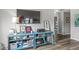 Living room showcasing blue shelving unit, decor, and view into the hall at 5299 Breakers Way, Carmel, IN 46033