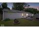 Backyard with a stone fire pit and outdoor seating, perfect for relaxing evenings outdoors at 5672 W New York St, Indianapolis, IN 46224