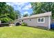 A well-maintained backyard with a hot tub, grill, and a lush green lawn, perfect for outdoor relaxation and entertainment at 5672 W New York St, Indianapolis, IN 46224