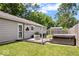 Backyard view showcases a wooden deck, a hot tub and patio area for outdoor relaxation and entertaining at 5672 W New York St, Indianapolis, IN 46224