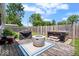 Backyard deck with fire pit, grill, and hot tub, ideal for entertaining and relaxing in a private outdoor setting at 5672 W New York St, Indianapolis, IN 46224