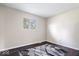 This bedroom features clean neutral walls, a large window that provides plenty of natural light, and sleek wood flooring at 5672 W New York St, Indianapolis, IN 46224