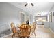 Bright dining area with a wooden table set, neutral walls, tile floor, and views of the kitchen and living spaces at 5672 W New York St, Indianapolis, IN 46224