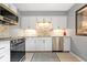 Modern kitchen featuring stainless steel appliances, white cabinets, and updated countertops at 5672 W New York St, Indianapolis, IN 46224